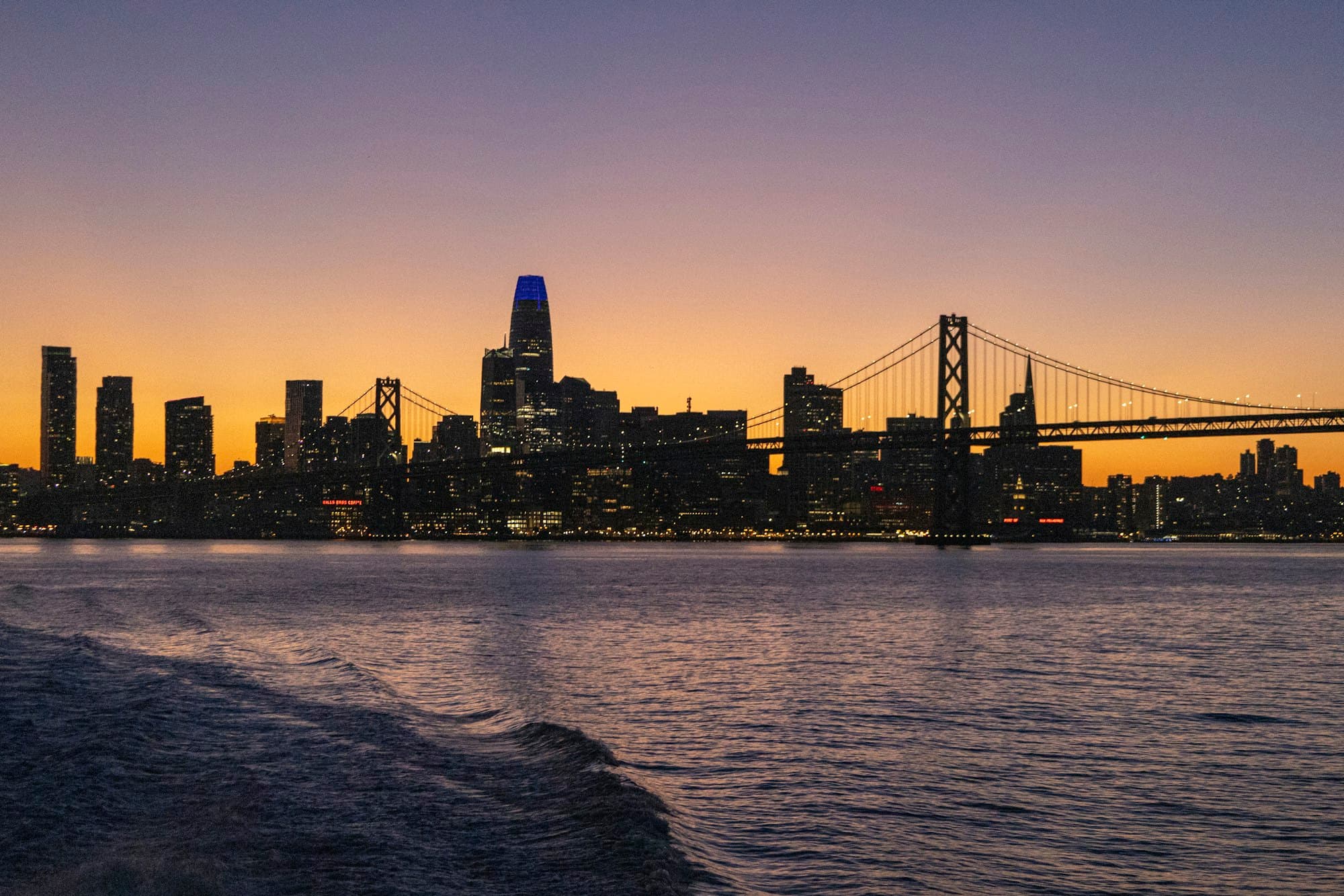 The San Francisco skyline and the Bay Bridge at sunset